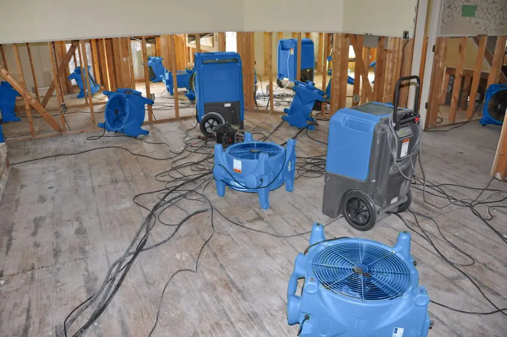 Air movers drying a gutted Dallas room after major water damage
